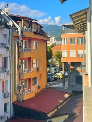 an apartment building with balconies and a parking lot at Lucy in Sandanski