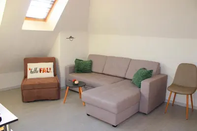 a living room with a couch and a chair at Lucy in Sandanski