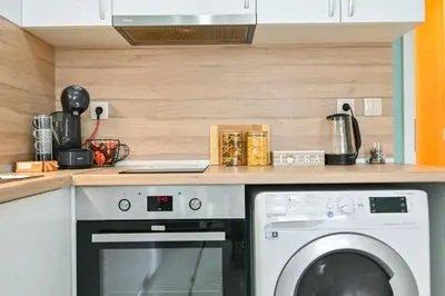a kitchen with a washing machine under a counter at Armand de Sanelle in Sofia