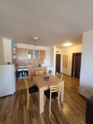 a kitchen and dining room with a table and chairs at Ramada2 Alexander Services Apartments in Bansko