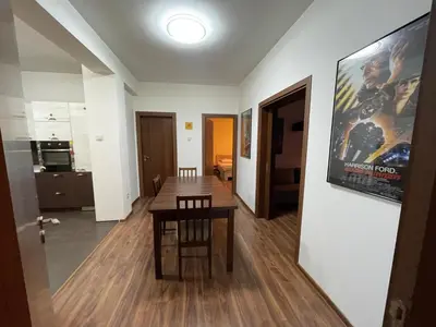 a living room with a table and a movie poster on the wall at Cinema house at Sofia center in Sofia