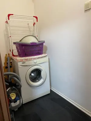 a washing machine with a basket on top of it at Cinema house at Sofia center in Sofia