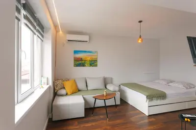 a small bedroom with a bed and a couch at Serdica Tower View DT Parking Wi-Fi AC in Sofia