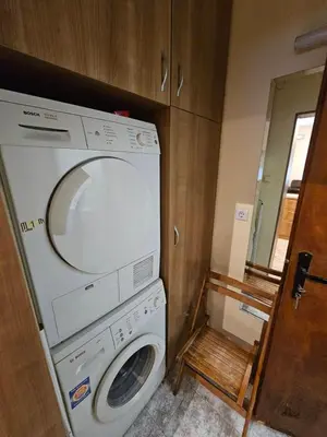 a washer and dryer in a small room at Bright and Cozy Studio with Garage near the Center in Sofia