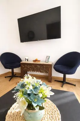 a living room with two chairs and a vase of flowers at Stylish apartment, top center with private Sauna! in Sofia
