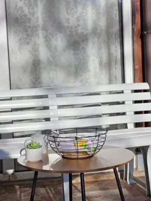 a wooden bench with a basket on a table at Two Big Bed Apartment & FREE Underground Parking in Sofia