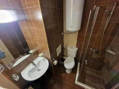 a bathroom with a toilet and a shower and a sink at Bansko Tower Cozy Studio with Mountain View in Bansko