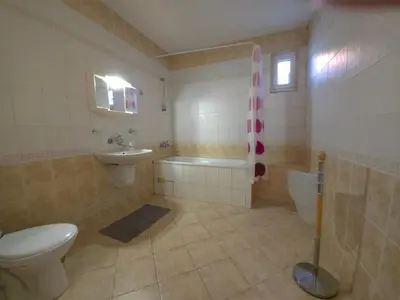 a bathroom with a toilet and a tub and a sink at Къща за гости У Нико in Orehovo