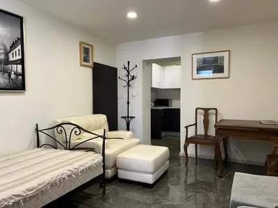 a bedroom with a bed and a desk and a piano at Sahat Tepe Studio in Plovdiv