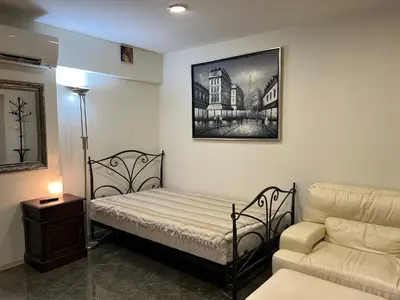 a small bedroom with a bed and a couch at Sahat Tepe Studio in Plovdiv