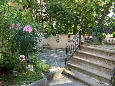 a staircase leading to a garden with pink flowers at Sahat Tepe Studio in Plovdiv