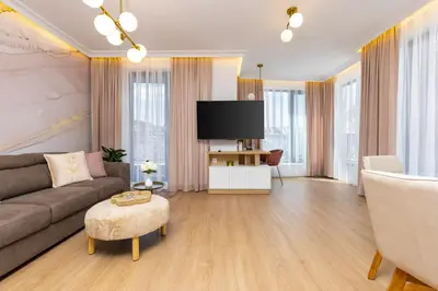 a living room with a couch and a flat screen tv at Stylish City Escape 1BD Apartment in Plovdiv in Plovdiv