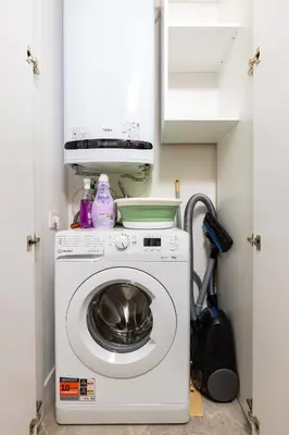 a washer and dryer in a small room at Stylish City Escape 1BD Apartment in Plovdiv in Plovdiv