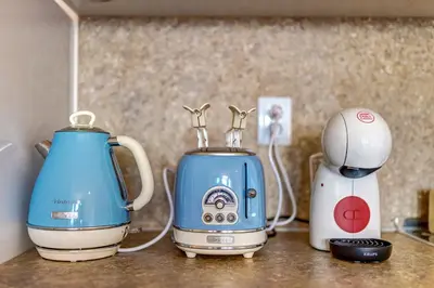 a blue and white blender and a toaster on a counter at Ski Slope Getaway at Grand Monastery in Pamporovo