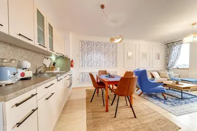 a kitchen and dining room with a table and chairs at Ski Slope Getaway at Grand Monastery in Pamporovo