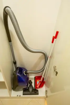 a vacuum cleaner and two pens on a wall at Cozy and warm apartment with a separate bedroom in Bansko