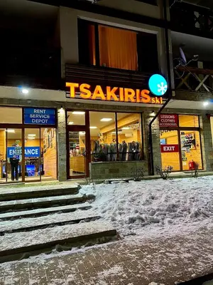a store front of a shopping center in the snow at Cozy and warm apartment with a separate bedroom in Bansko