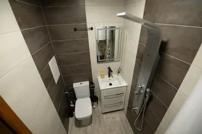a small bathroom with a toilet and a sink at Апартамент Милена in Smolyan