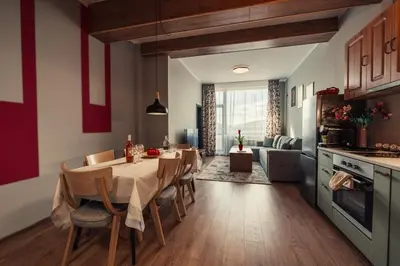 a kitchen and dining room with a table and chairs at Rila Zen Apartment in Samokov