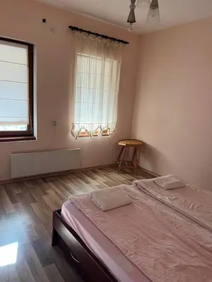 a bedroom with a large bed and a window at Country House БатЖоро