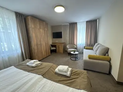 a hotel room with a bed and a couch at Alen Mak in Govedartsi