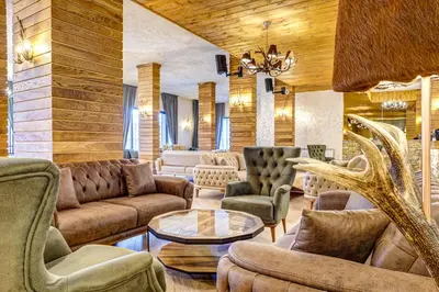 a living room with couches and chairs and a table at Grand Resort Pamporovo Apartments in Pamporovo