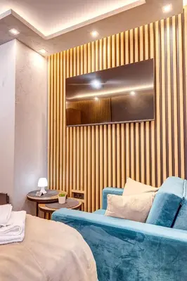 a room with two beds and a wall with stripes at Grand Resort Pamporovo Apartments in Pamporovo