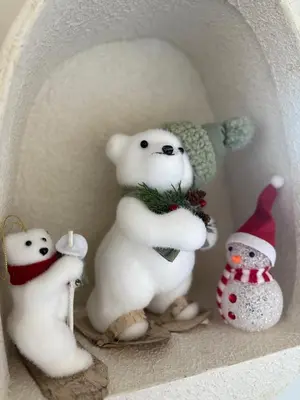a group of stuffed polar bears and snowmen on a shelf at Appartement moderne et chic Ski & Spa Bansko in Bansko