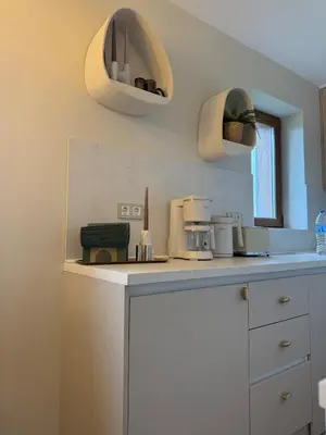 a kitchen with two pendant lights on the wall at Appartement moderne et chic Ski & Spa Bansko in Bansko