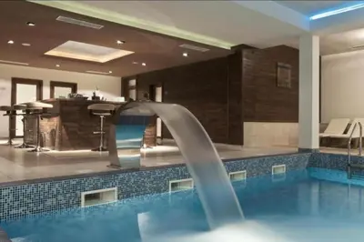 a swimming pool with a water slide in a house at Appartement moderne et chic Ski & Spa Bansko in Bansko