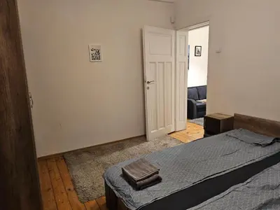 a bedroom with a bed with two towels on it at Super Central 2BR FREE Parking in Sofia