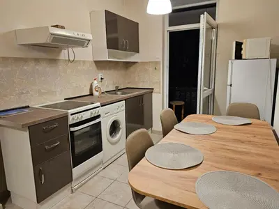 a kitchen with a table and a stove and a sink at Super Central 2BR FREE Parking in Sofia
