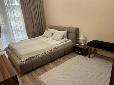 a large bed in a room with a large window at Guest House Amaya Med 2 in Plovdiv