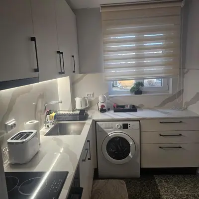 a kitchen with a washing machine and a sink at Luxury Suite Old Plovdiv with parking in Plovdiv