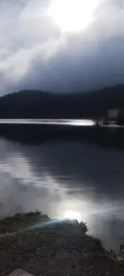 a large body of water with the sun in the background at Гранд Манастира 4А30 Весела Ваканция in Pamporovo