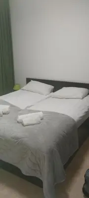 a large white bed with two white towels on it at Гранд Манастира 4А30 Весела Ваканция in Pamporovo