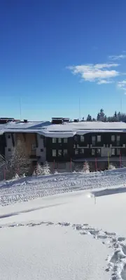 a building in the snow in front of a building at Гранд Манастира 4А30 Весела Ваканция in Pamporovo