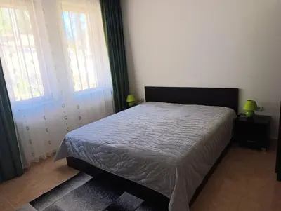a bedroom with a bed and two windows at Гранд Манастира 4А30 Весела Ваканция in Pamporovo