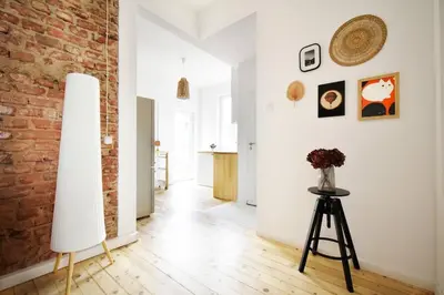 a living room with a brick wall and a tripod at Boho Gem in Sofia