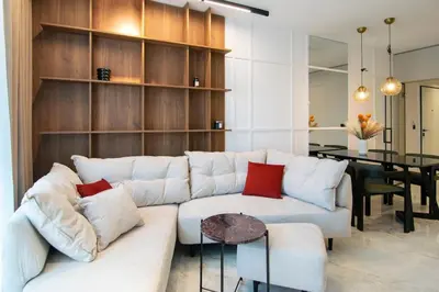 a living room with a white couch and a table at Alta Vita - Brand New - Luxury - Parking - Wash&Dry - Gas Heating in Sofia