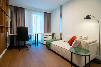 a room with a couch and a desk and a television at Alta Vita - Brand New - Luxury - Parking - Wash&Dry - Gas Heating in Sofia