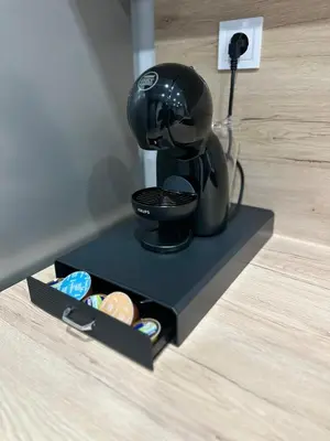a black coffee maker on a black box on a counter at Le bijou-Беломорски in Plovdiv