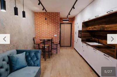 a living room with a couch and a brick wall at Le bijou-Tomov Plaza in Plovdiv