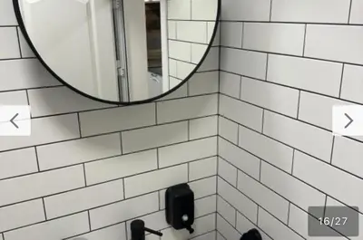a bathroom with a mirror and a sink at Le bijou-Tomov Plaza in Plovdiv