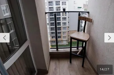 a chair sitting on a balcony with a window at Le bijou-Tomov Plaza in Plovdiv
