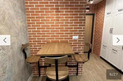 a wooden table in front of a brick wall at Le bijou-Tomov Plaza in Plovdiv