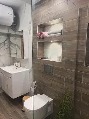 a bathroom with a toilet and a sink at Boutique apartment family 5 in Plovdiv