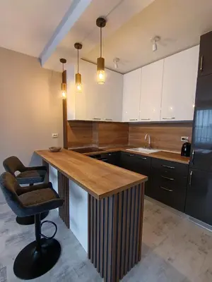 a kitchen with a wooden counter and a chair at Boutique apartment family 5 in Plovdiv