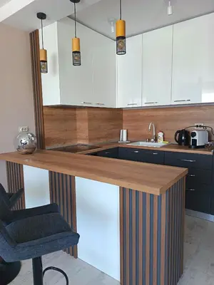 a kitchen with a wooden counter with a sink at Boutique apartment family 5 in Plovdiv
