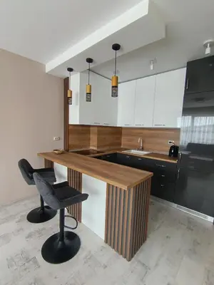 a kitchen with a wooden counter and a black refrigerator at Boutique apartment family 5 in Plovdiv